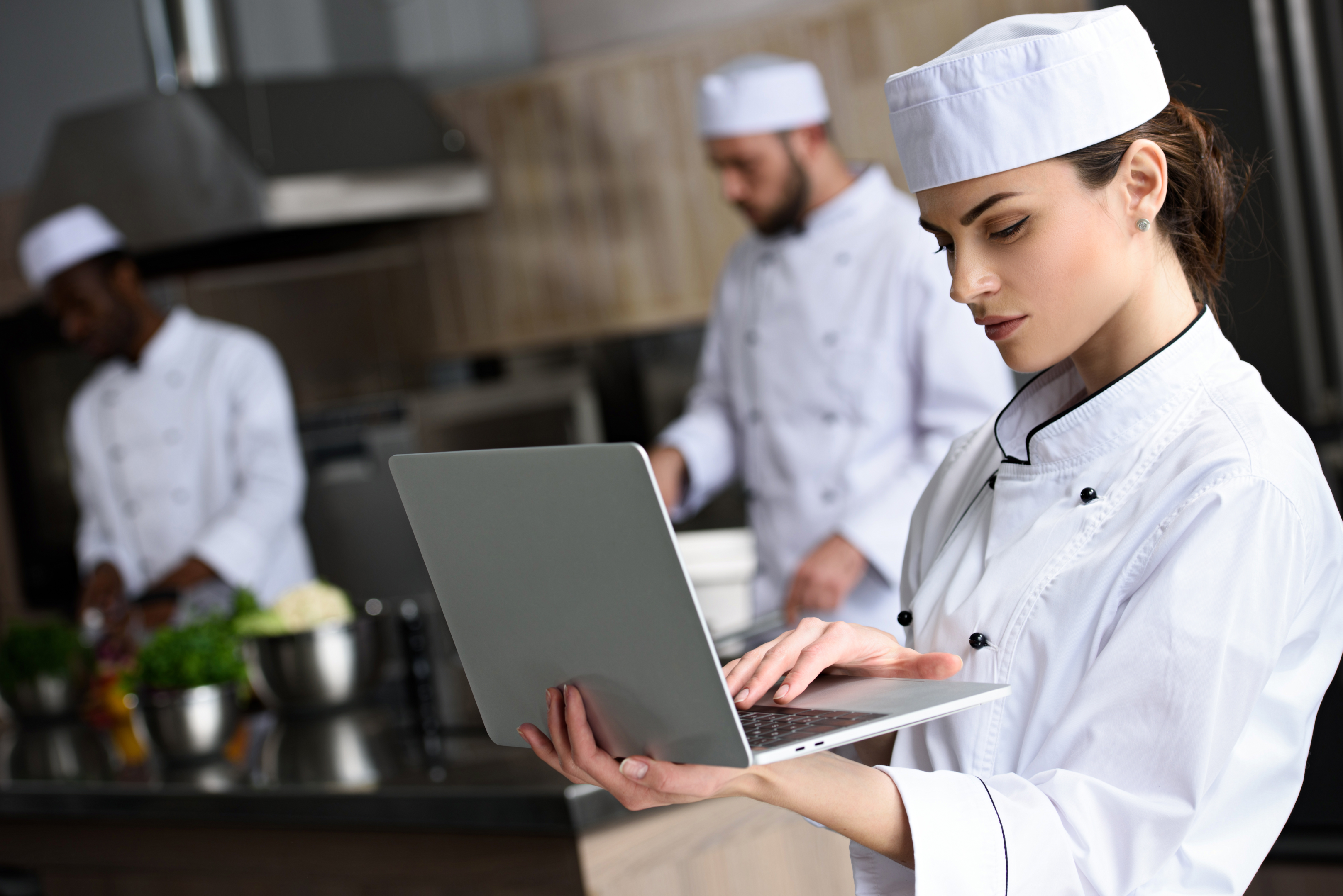 A chef looking at a restaurant's paid advertisement on social media